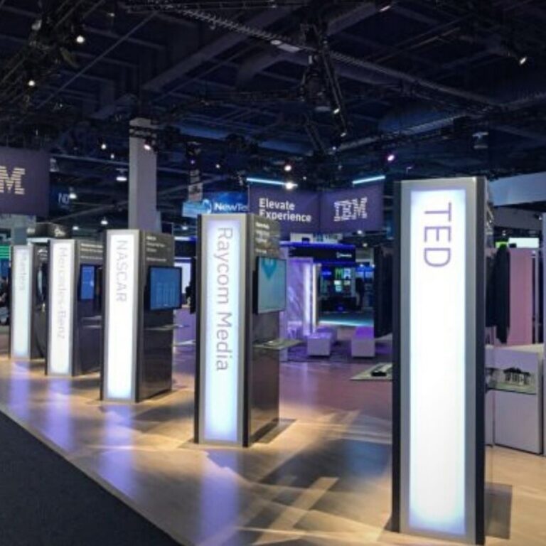 a trade show floor with blue light up columns