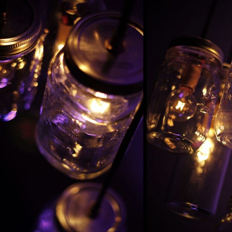 mason jars that have been turned into electric lights with purple uplights in the background